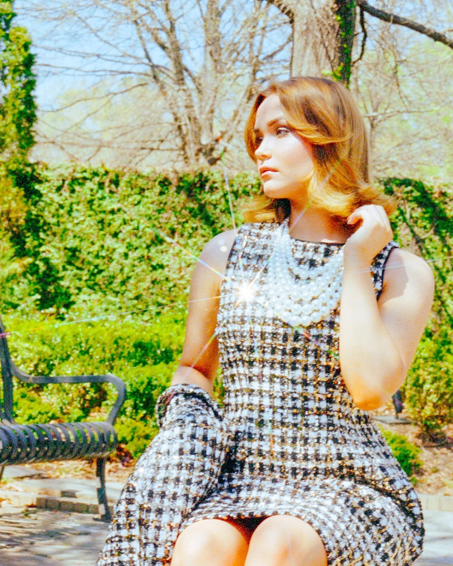 Editorial garden portrait with pearls and tweed styling on Portra film
