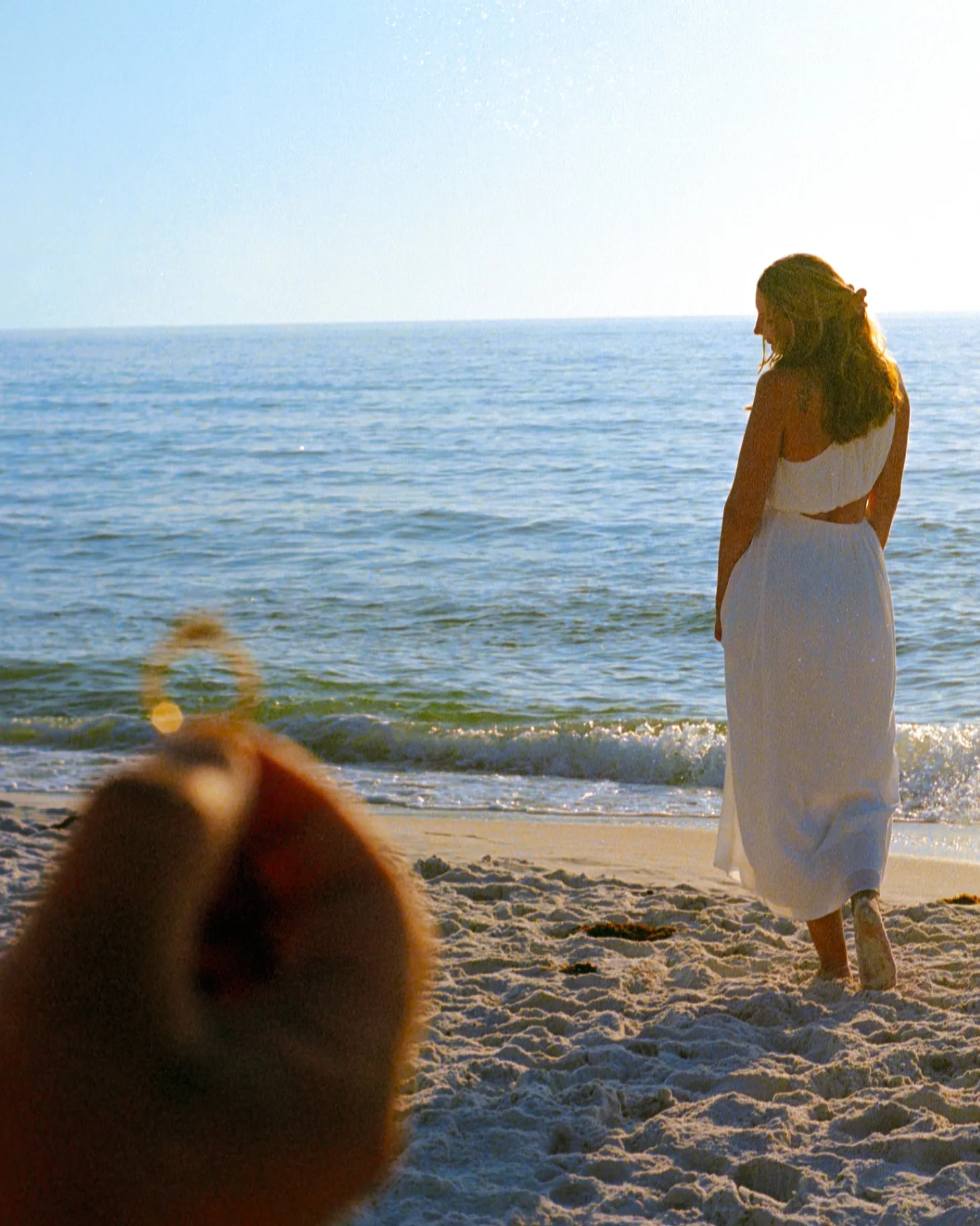 Couple embracing on the beach during an engagement photography session