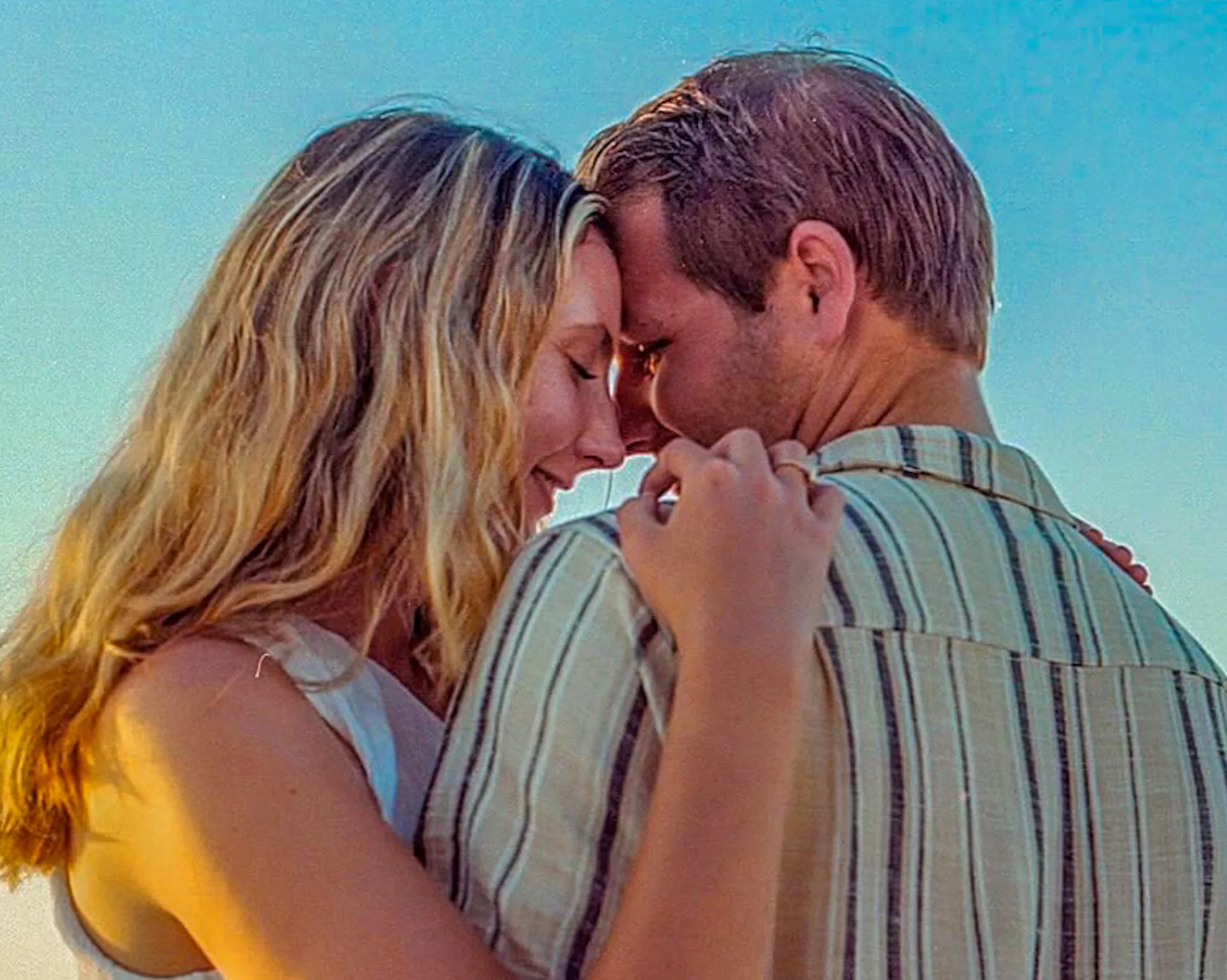 Engaged couple touching foreheads in a quiet Portra film portrait