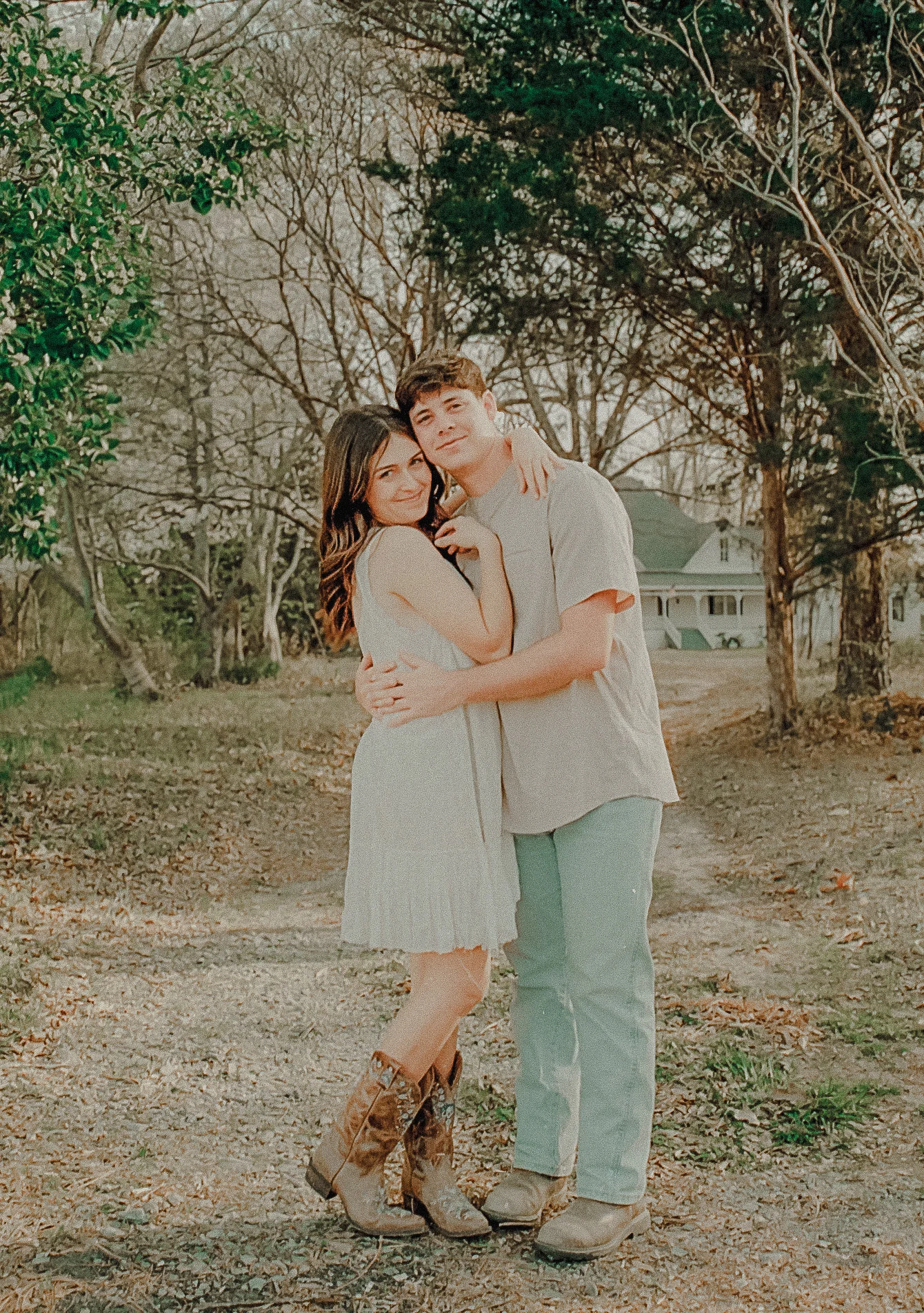 Couple embracing on the beach at golden hour, relaxed engagement session portrait