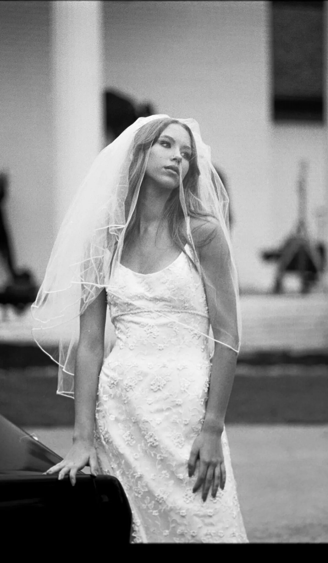 Bride with flowing veil walking outdoors, documentary wedding photography on film