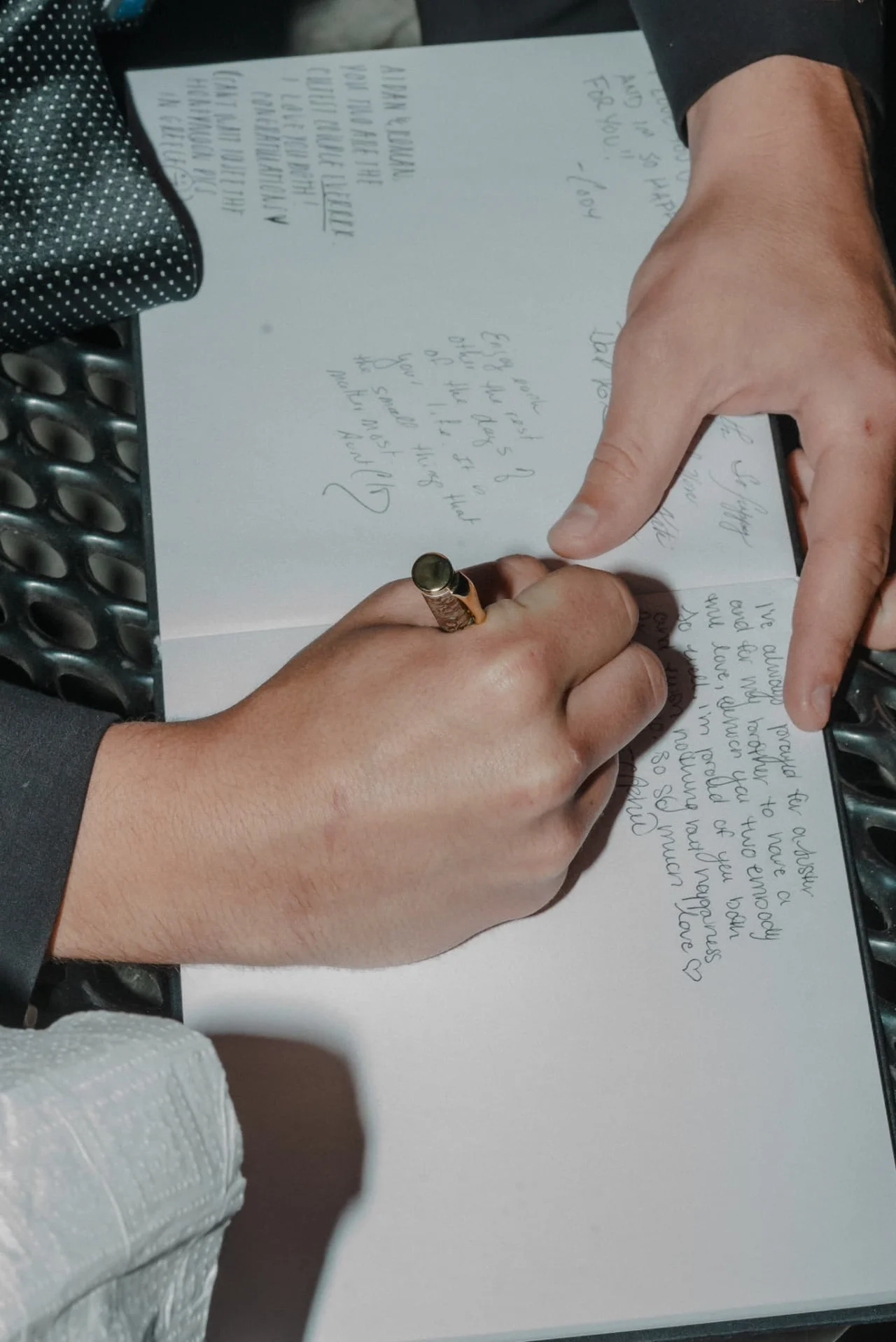 Guests signing the couple's guest book at the wedding reception
