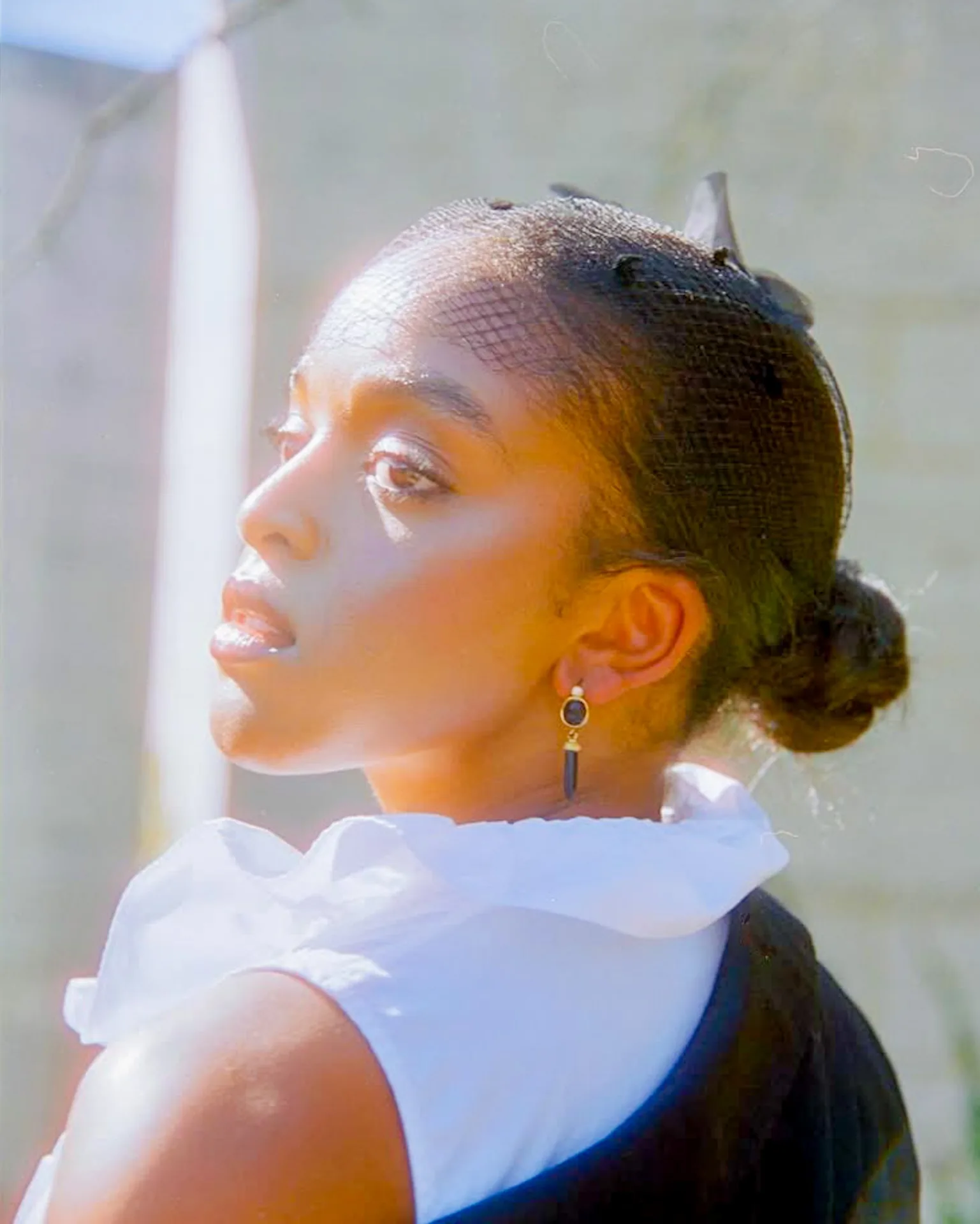Garden editorial portrait with a ruffled collar and delicate film texture