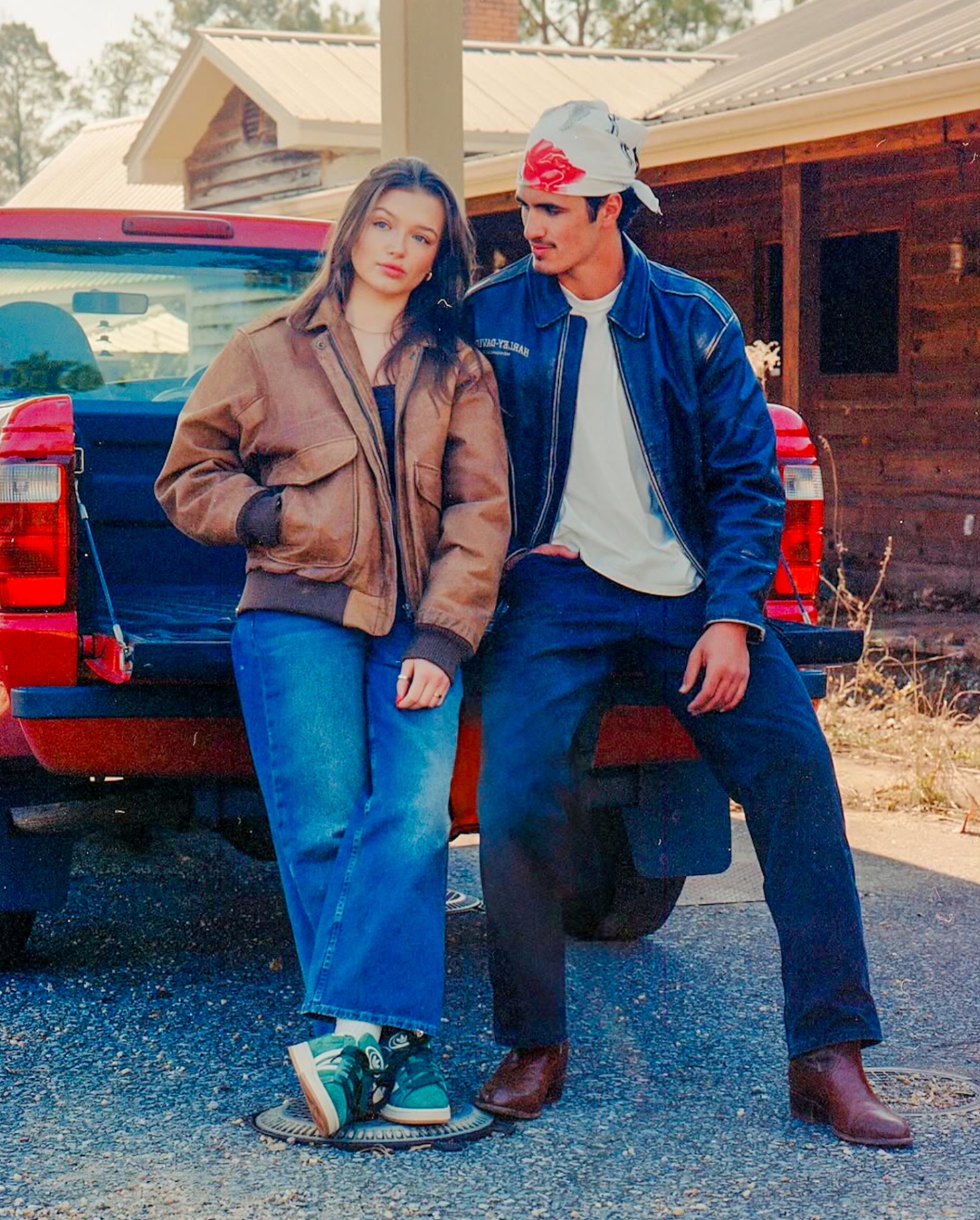 Couple leaning into a vintage truck during an editorial engagement session